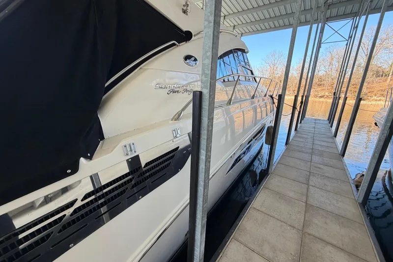Slide: The Image of 2014 Sea Ray 540 Sundancer docked in a covered marina. - 11