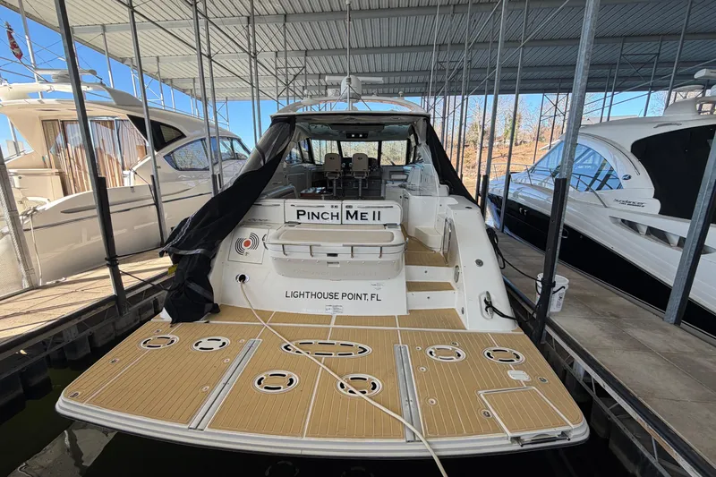 Slide: The Image of 2014 Sea Ray 540 Sundancer yacht docked at marina, rear view. - 12