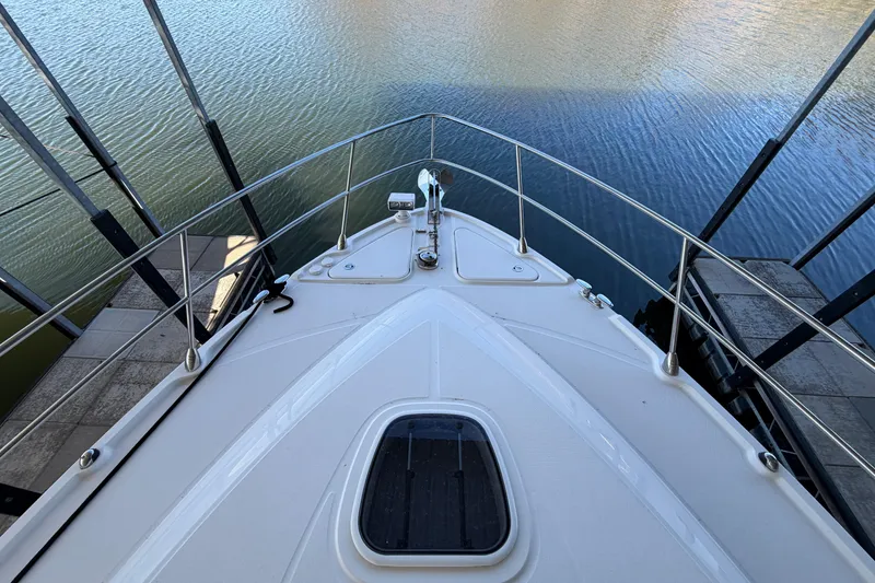 Slide: The Image of Bow view of 2014 Sea Ray 540 Sundancer yacht docked by the water. - 15