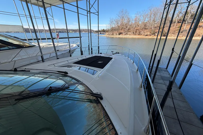 Slide: The Image of 2014 Sea Ray 540 Sundancer yacht docked in a serene marina setting. - 16