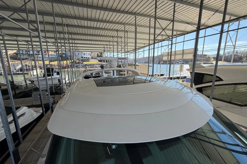 Slide: The Image of 2014 Sea Ray 540 Sundancer yacht docked under a covered marina. - 17