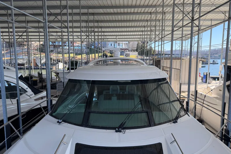 Slide: The Image of 2014 Sea Ray 540 Sundancer yacht docked in a covered marina. - 18