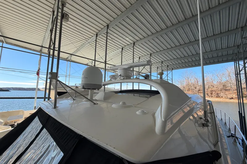 Slide: The Image of 2014 Sea Ray 540 Sundancer yacht docked under a covered marina. - 20