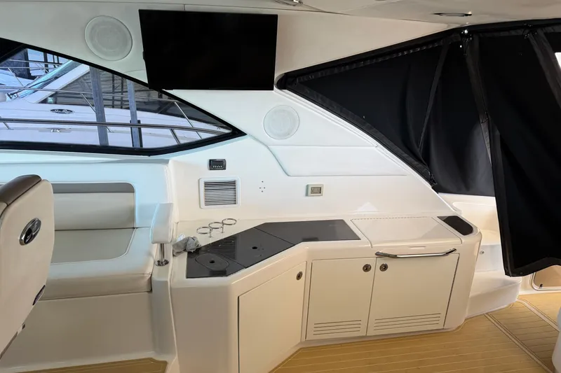 Slide: The Image of Interior of 2014 Sea Ray 540 Sundancer yacht with modern seating and cabinetry. - 24