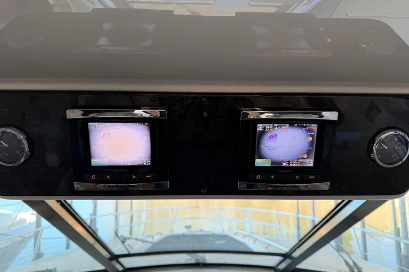 Slide: The Image of Control panel of a 2014 Sea Ray 540 Sundancer yacht with navigation screens. - 29
