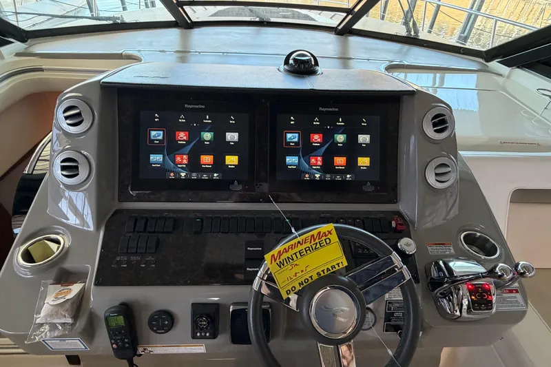 Slide: The Image of Control panel of a 2014 Sea Ray 540 Sundancer yacht with dual Raymarine displays. - 30