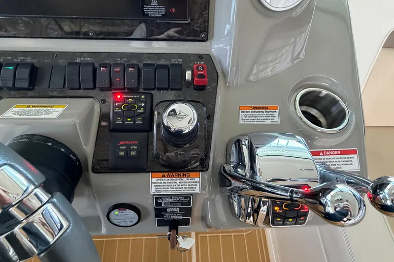 Slide: The Image of Control panel of 2014 Sea Ray 540 Sundancer boat with steering and throttle controls. - 32