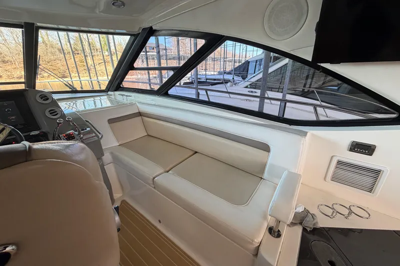 Slide: The Image of Interior of 2014 Sea Ray 540 Sundancer yacht with beige seating and control panel. - 37