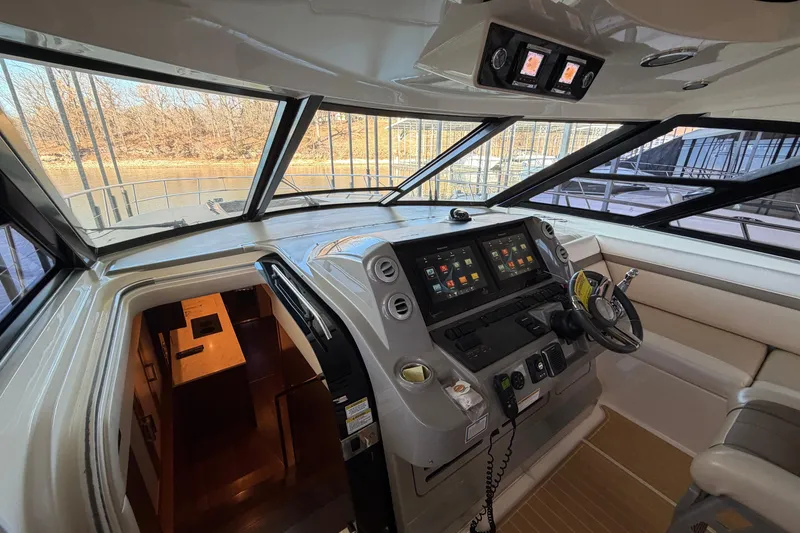 Slide: The Image of Interior view of 2014 Sea Ray 540 Sundancer yacht cockpit with modern navigation controls. - 38