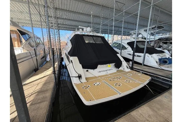 Slide: The Image of 2014 Sea Ray 540 Sundancer yacht docked in a covered marina. - 4