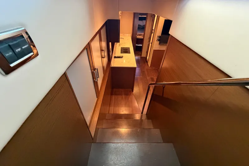 Slide: The Image of Interior view of 2014 Sea Ray 540 Sundancer yacht, featuring modern staircase and sleek design. - 42