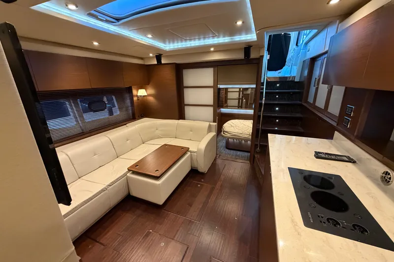 Slide: The Image of Luxurious interior of 2014 Sea Ray 540 Sundancer yacht with modern seating and kitchen area. - 46