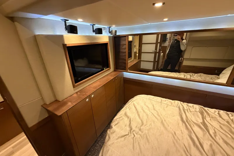 Slide: The Image of Luxurious interior of 2014 Sea Ray 540 Sundancer yacht bedroom with modern amenities. - 49