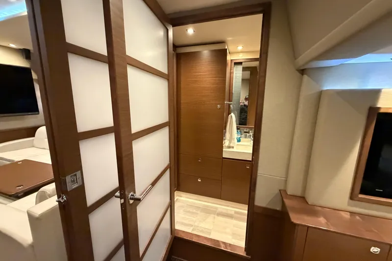 Slide: The Image of Luxurious interior of 2014 Sea Ray 540 Sundancer yacht, featuring modern bathroom and living area. - 50