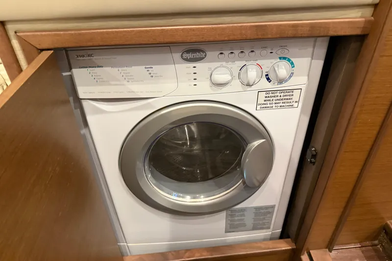 Slide: The Image of Splendide washer in 2014 Sea Ray 540 Sundancer yacht, wooden cabinet open. - 52