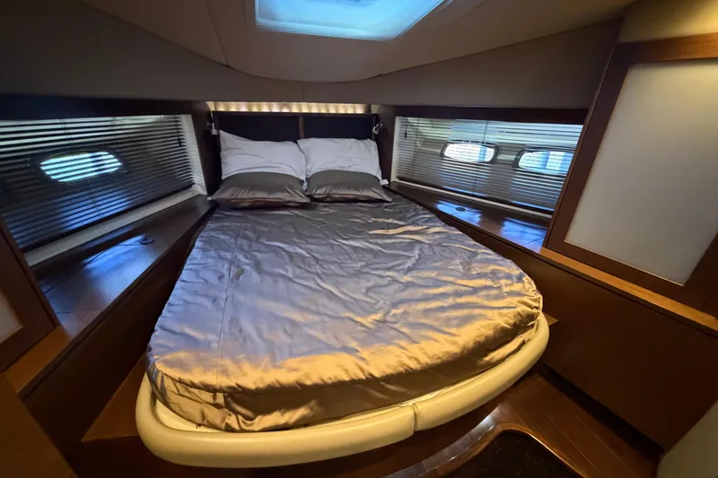 Slide: The Image of Luxurious bedroom interior of 2014 Sea Ray 540 Sundancer yacht with skylight and elegant bedding. - 56