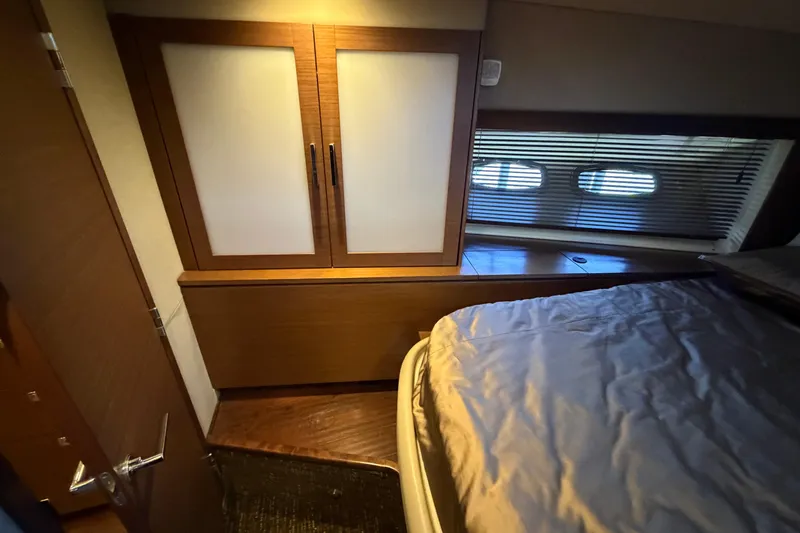 Slide: The Image of Luxurious cabin interior of 2014 Sea Ray 540 Sundancer yacht with bed and storage. - 58