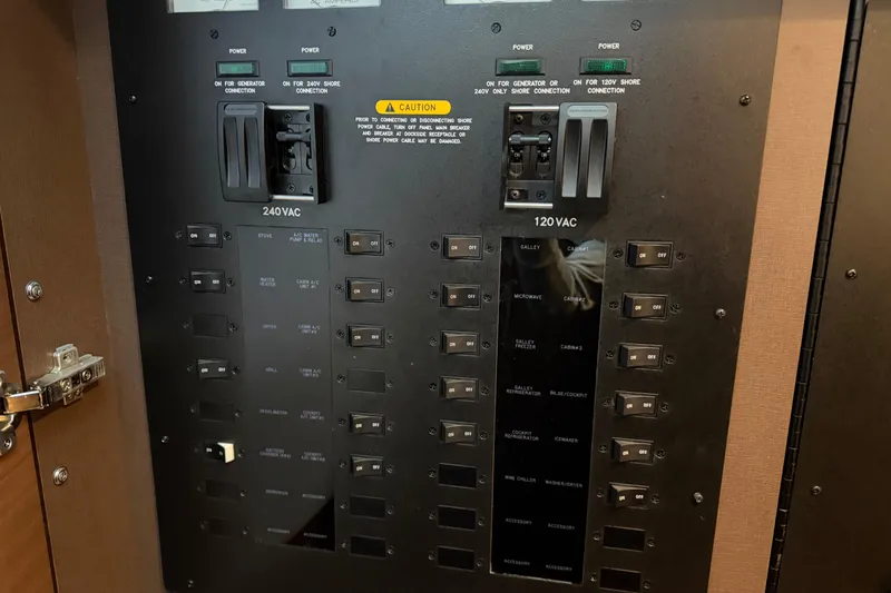 Slide: The Image of Electrical panel of a 2014 Sea Ray 540 Sundancer yacht, showing 240VAC and 120VAC switches. - 63