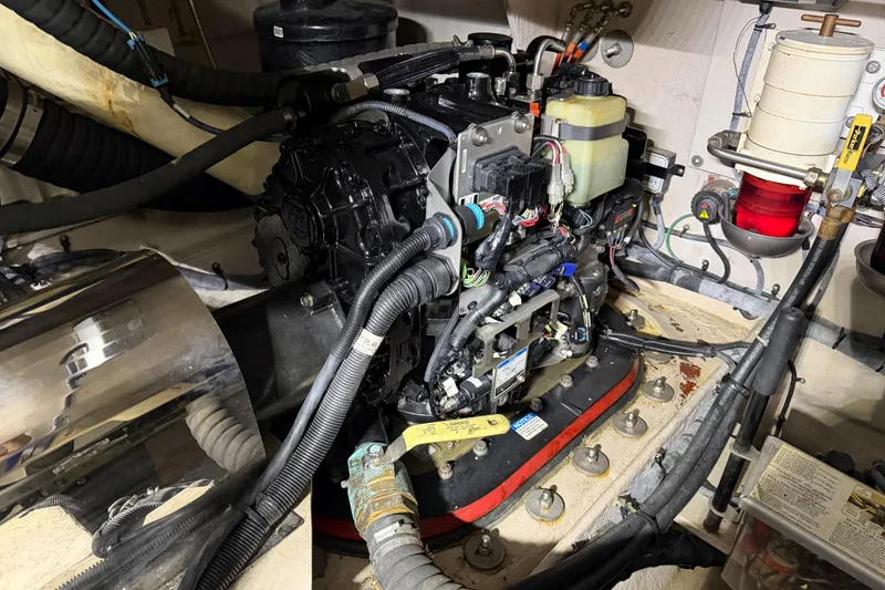 Slide: The Image of Engine compartment of a 2014 Sea Ray 540 Sundancer with visible wiring and components. - 79
