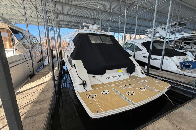 Slide: The Image of 2014 Sea Ray 540 Sundancer yacht docked in a covered marina. - 8