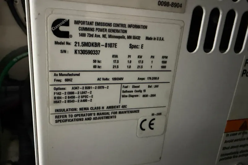 Slide: The Image of Cummins power generator label on 2014 Sea Ray 540 Sundancer, model 21.5MDKBR-8107E. - 82