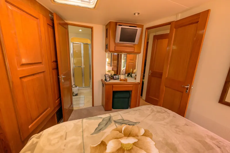 Slide: The Image of Luxurious interior of 1997 Viking 58 Enclosed Bridge yacht with wood finishes and cozy decor. - 15