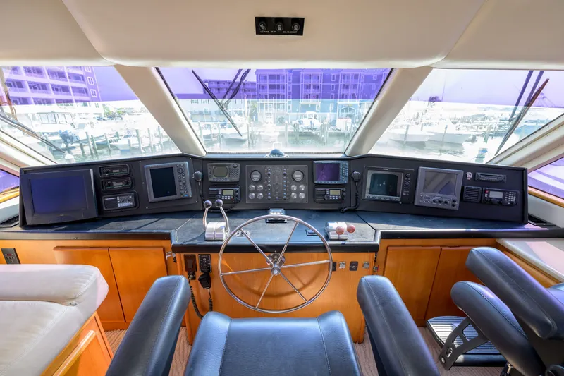 Slide: The Image of Cockpit of 1997 Viking 58 Enclosed Bridge yacht with navigation instruments and steering wheel. - 26