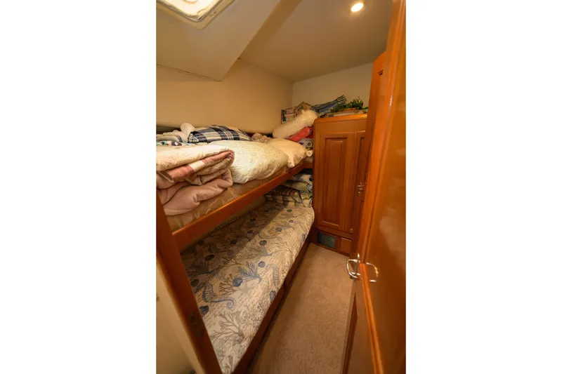Slide: The Image of Cozy bunk beds in 1997 Viking 58 Enclosed Bridge yacht cabin. - 11