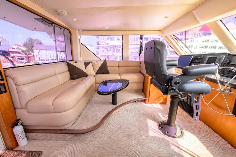 Slide: The Image of Luxurious interior of a 1997 Viking 58 Enclosed Bridge yacht with plush seating and helm. - 25