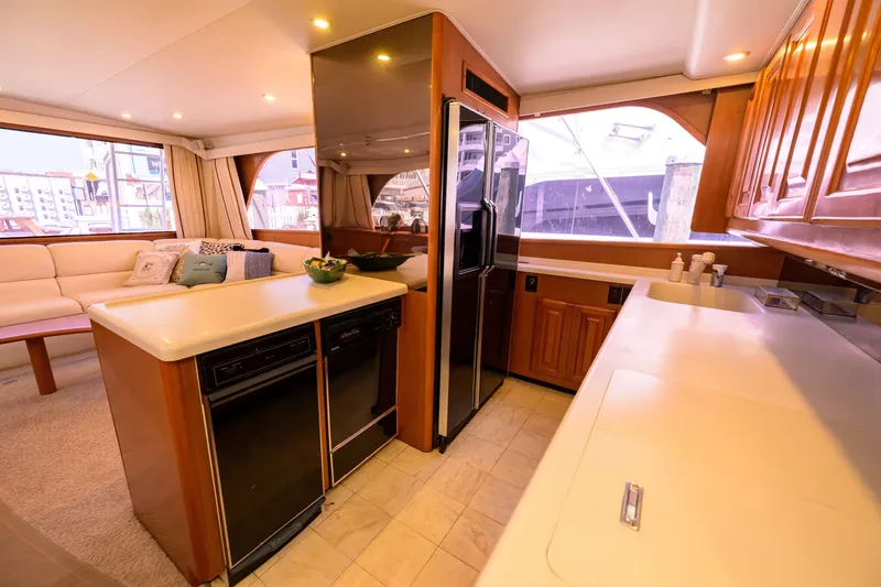 Slide: The Image of Luxurious interior of 1997 Viking 58 Enclosed Bridge yacht with modern kitchen amenities. - 9