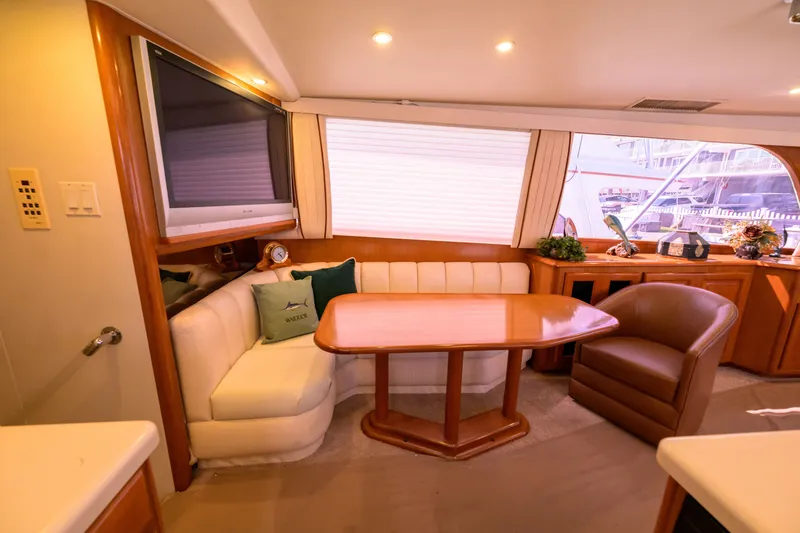 Slide: The Image of Luxurious interior of a 1997 Viking 58 Enclosed Bridge yacht with elegant seating area. - 10