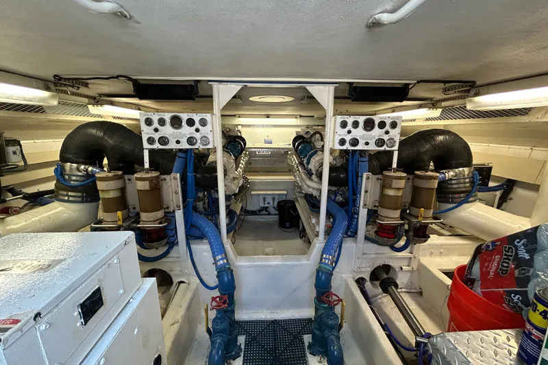 Slide: The Image of Engine room of 1997 Viking 58 Enclosed Bridge yacht, featuring complex machinery and piping. - 33