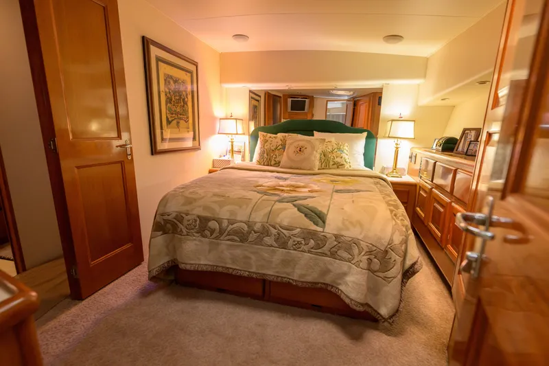 Slide: The Image of Luxurious bedroom interior of a 1997 Viking 58 Enclosed Bridge yacht, featuring elegant decor. - 14