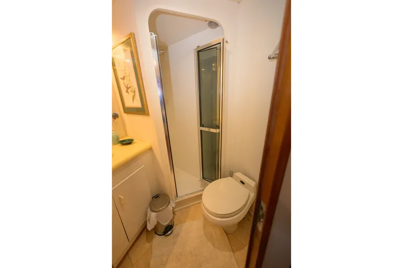 Slide: The Image of Bathroom interior of 1997 Viking 58 Enclosed Bridge yacht, featuring shower and toilet. - 20