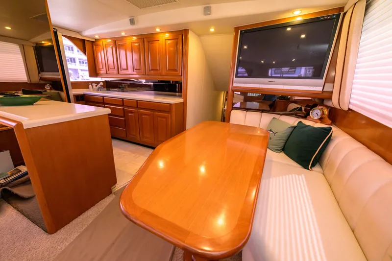 Slide: The Image of Luxurious interior of 1997 Viking 58 Enclosed Bridge yacht with dining area and kitchen. - 6