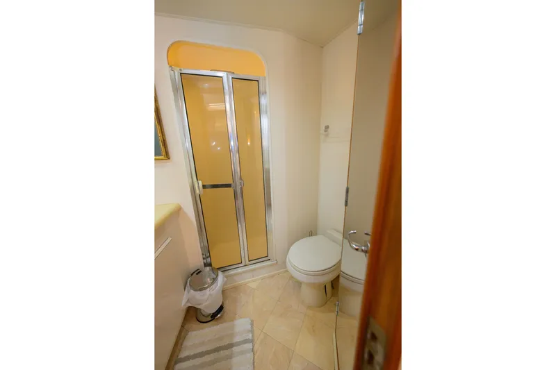 Slide: The Image of Bathroom interior of 1997 Viking 58 Enclosed Bridge yacht, featuring shower and toilet. - 16