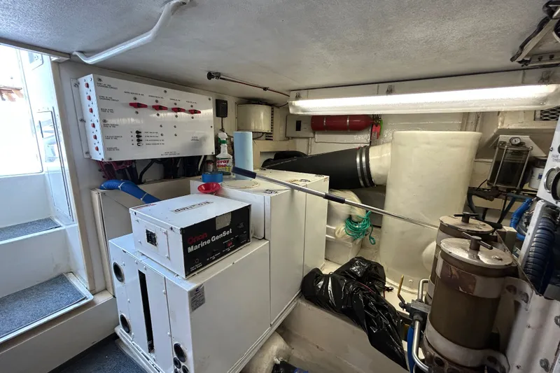 Slide: The Image of Engine room of 1997 Viking 58 Enclosed Bridge with marine generator and control panel. - 32