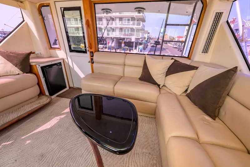 Slide: The Image of Luxurious interior of 1997 Viking 58 Enclosed Bridge yacht with beige leather seating. - 28