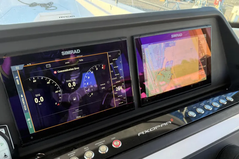 Slide: The Image of Dashboard of 2021 Axopar 28 Cabin with Simrad navigation displays. - 13