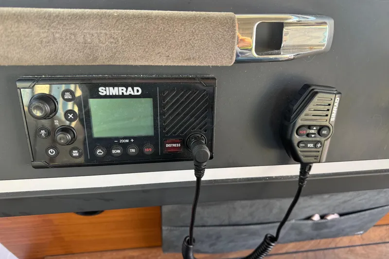 Slide: The Image of Simrad marine radio system on 2021 Axopar 28 Cabin boat dashboard. - 14