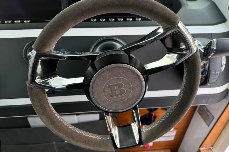 Slide: The Image of Steering wheel of a 2021 Axopar 28 Cabin boat, featuring sleek design and modern controls. - 19