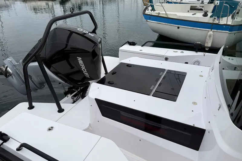 Slide: The Image of 2021 Axopar 28 Cabin boat with Mercury engine, docked in marina. - 2