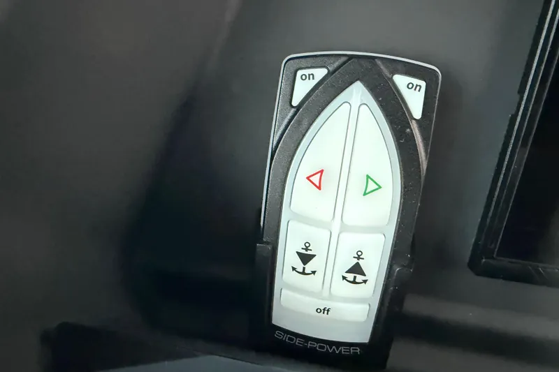 Slide: The Image of Control panel of a 2021 Axopar 28 Cabin boat with directional buttons. - 21