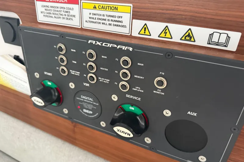 Slide: The Image of Control panel of a 2021 Axopar 28 Cabin boat with various switches and warnings. - 31