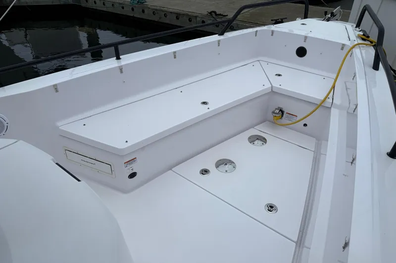 Slide: The Image of 2021 Axopar 28 Cabin boat deck with seating and storage compartments. - 32