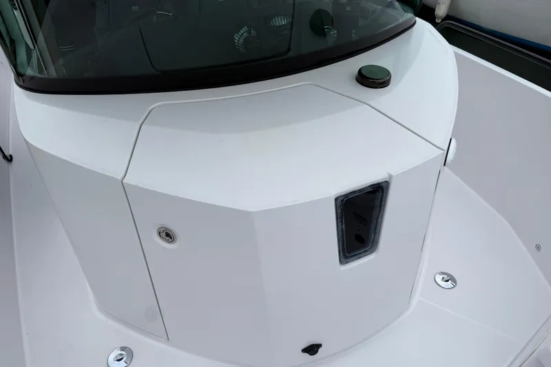 Slide: The Image of 2021 Axopar 28 Cabin boat deck with sleek white design. - 34