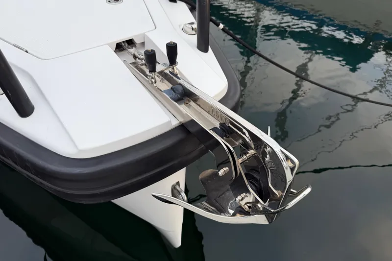 Slide: The Image of Anchor detail of 2021 Axopar 28 Cabin boat, reflecting on water. - 40