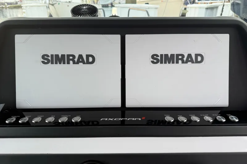 Slide: The Image of Dashboard of 2021 Axopar 28 Cabin with dual Simrad displays. - 41