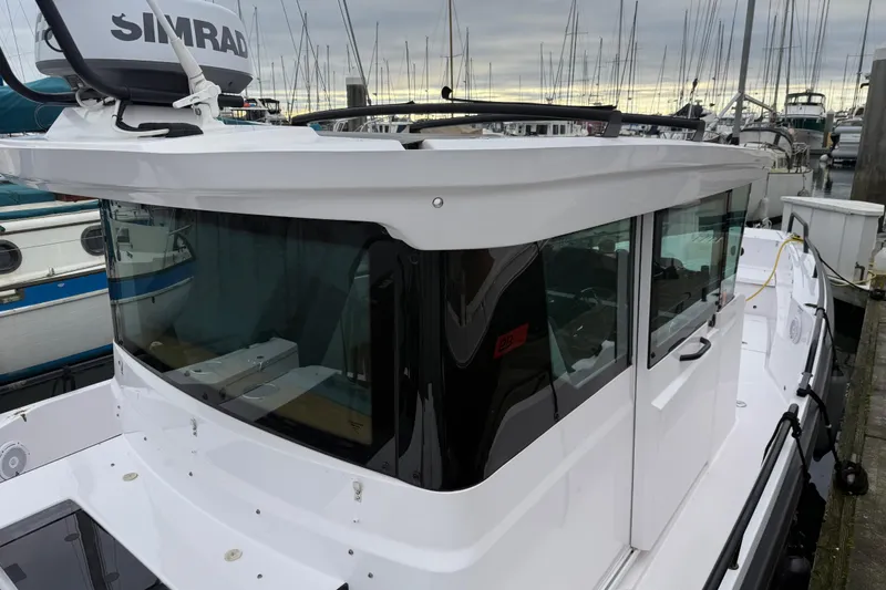 Slide: The Image of 2021 Axopar 28 Cabin boat docked in marina, featuring sleek design and modern equipment. - 8