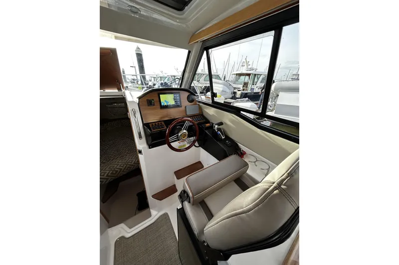 Slide: The Image of 2024 Cutwater 248 boat interior with modern helm, steering wheel, and navigation display. - 13